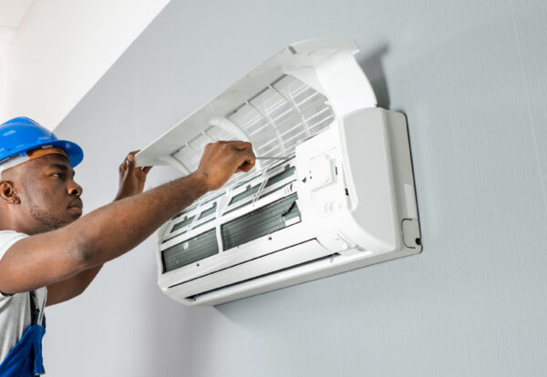 Happy,Young,African,Male,Technician,Repairing,Air,Conditioner Happy,Young,African,Male,Technician,Repairing,Air,Conditioner